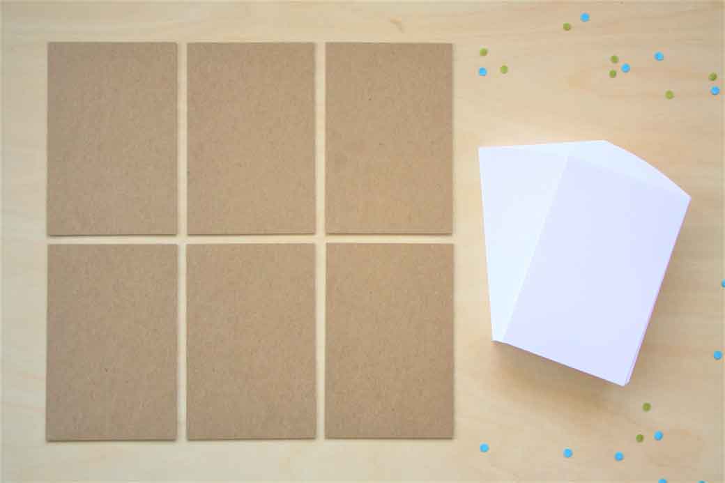 notepad paper 4 x 6 in and 6 cardboard backs laying out on table