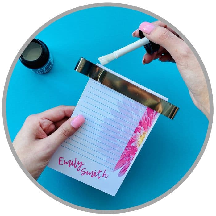 demonstration of applying padding compound to a diy notepad with Get-Noted padding compound brush in bottle lid